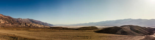 Sandy desert plain with rocky mountains witout life in Death Valley at sunny day, america Sandy desert plain with rocky mountains witout life in Death Valley in america at sunny day, usa witout stock pictures, royalty-free photos & images