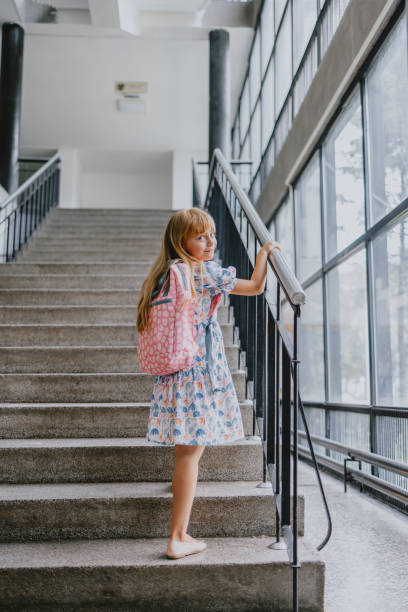 istock Young Girl Walking Up School Stairs With Backpack 2163029153