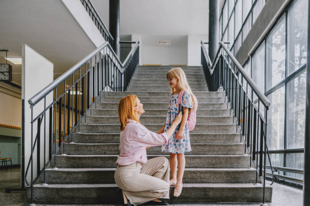 istock Mother Taking Daughter To School On First Day Back 2163029178