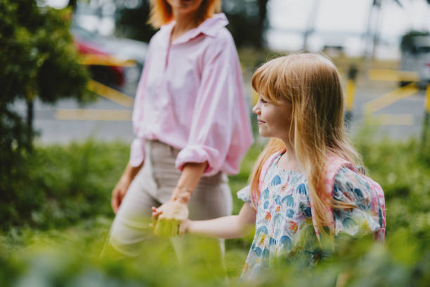 Mother Walking Daughter to School on First Day Back