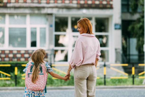istock Mom Takes Daughter to School on First Day Back 2163029237