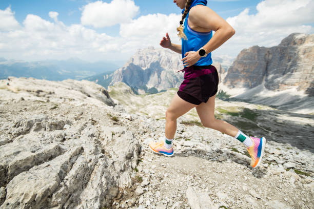 istock Woman running on mountain trail. 2163032998