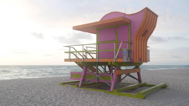 istock Miami Beach Sunrise: Pink Lifeguard Tower and Golden Waves 2163033613