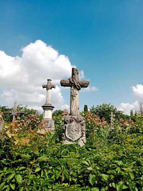 istock A stone cross among green trees 2163038063