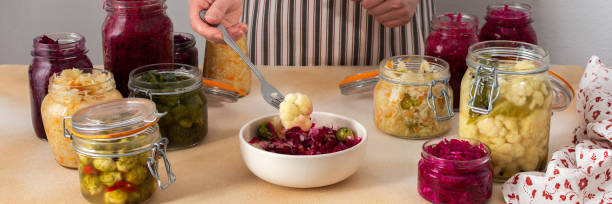 istock Woman fermenting fresh vegetables 2163038295