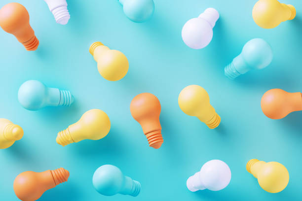 istock Colorful Light Bulbs On Blue Background 2163039308