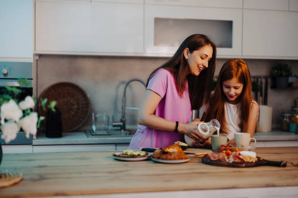 istock Mother and daughter making dinner at kitchen 2163041203
