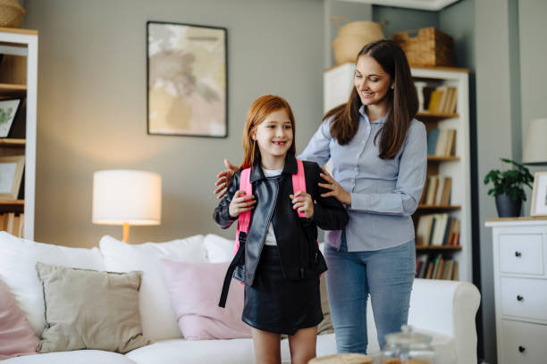 istock Mother Helping Her Cute Daughter Get Ready for School 2163041399