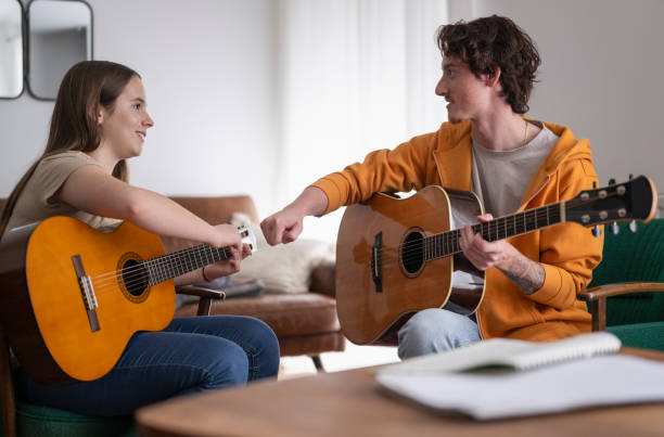 istock Young Guitar Instructor Gives Private Lesson To Female Student 2163042642