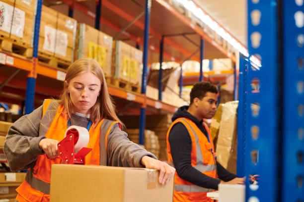 istock young warehouse worker in packing department 2163043398