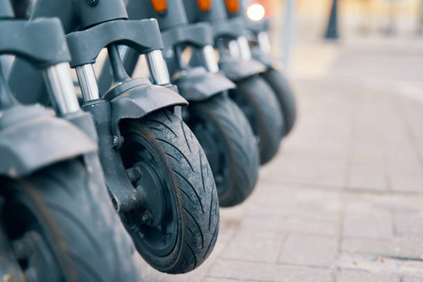 istock Row of scooters with rubber tires parked on sidewalk 2163043552