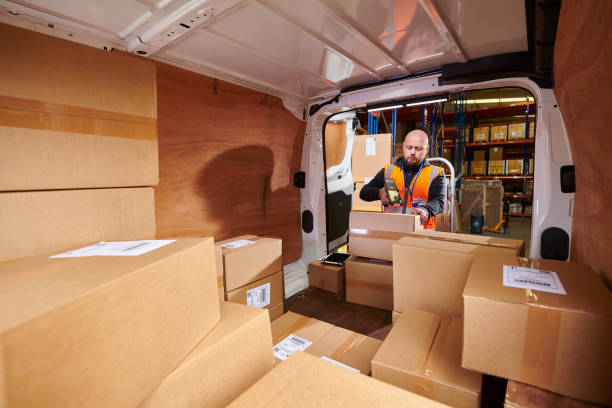 istock warehouse delivery man scanning items 2163043807