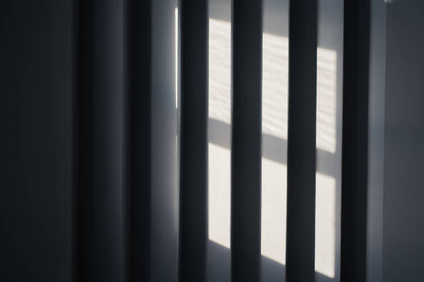 istock Close up view of an abstract black background with geometric vertical slats, backdrop with copy space, light and shadow pattern. Stylish template, mock up for your design, art, poster, presentation 2163044367