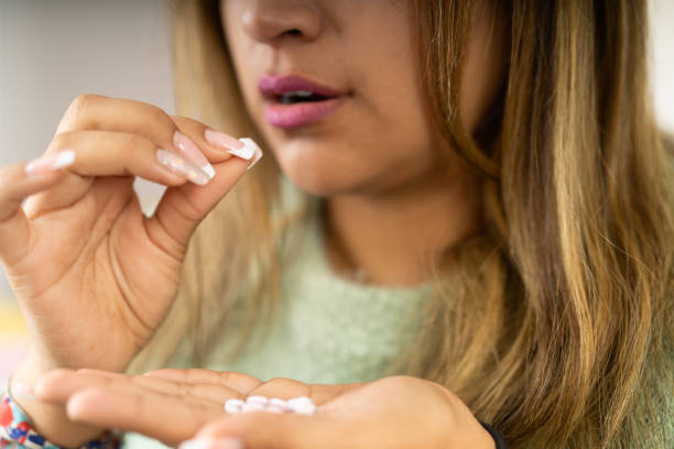 istock Unrecognizable depressed woman taking pills at home 2163044679