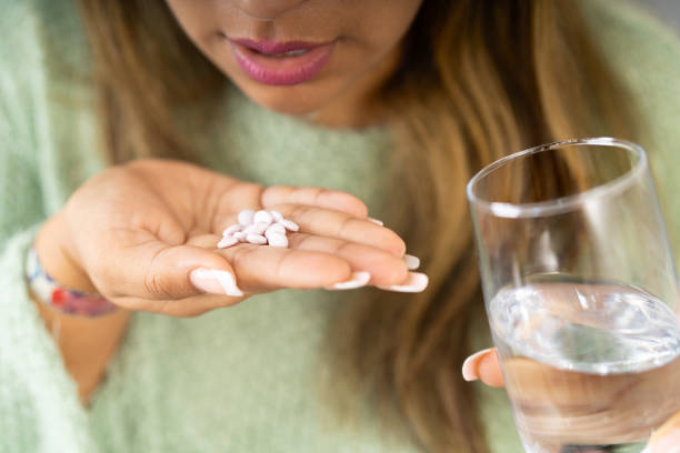 istock Woman taking medicine to treat mental problems 2163044838