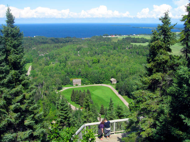 High angle view of Saguenay-Lac-Saint-Jean, viewpoint, rear view of young couple, lake in the background. Quebec, Canada.