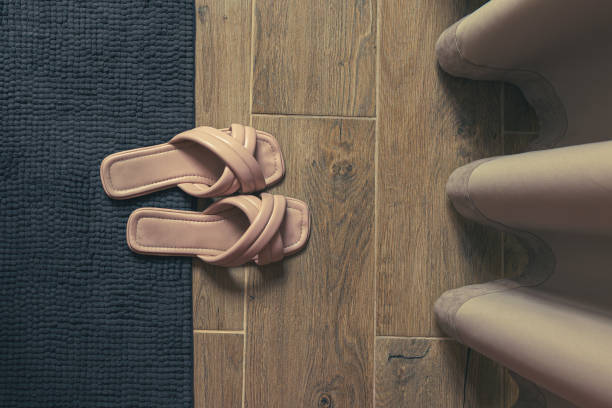 istock Pink women's flip flops on the carpet top view 2163047658