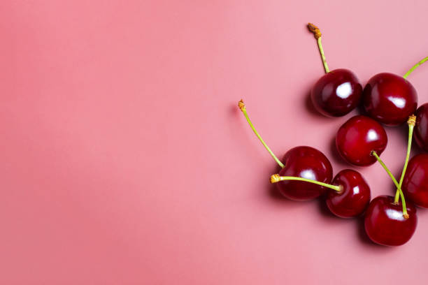 istock Sweet juicy cherries on a pink background 2163048287