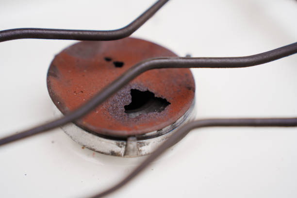 An old broken rusted burner of a gas stove. replacement and repair of kitchen equipment.