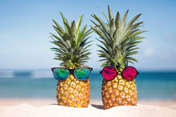 istock Two pineapples with trendy sunglasses in tropical paradise 2163048809