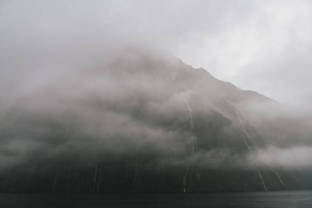 istock Fog-Covered Mountain with Misty Waterfalls 2163049789