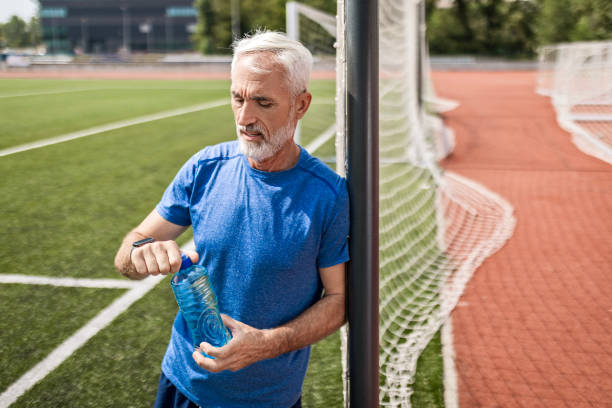 istock Confident Senior Athlete Refreshes After Stadium Run 2163051749