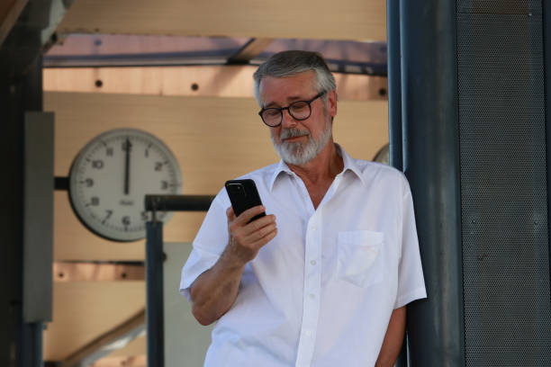 istock Senior man on station with phone 2163051882