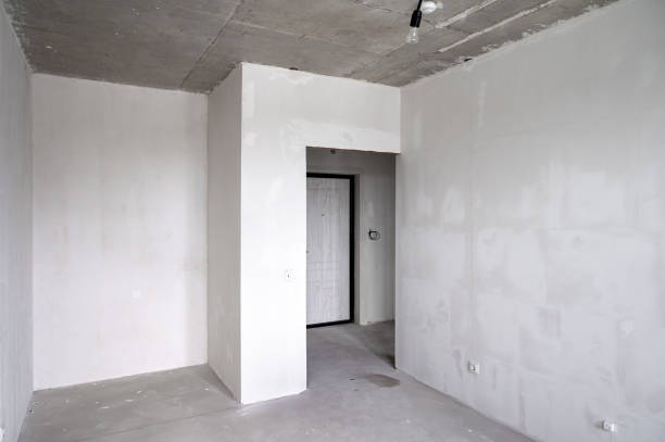 istock The room is vacant, adorned with white walls and a solitary door inside 2163055310