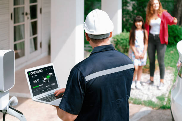 istock Qualified technician working with laptop for home EV station. Synchronos 2163056472