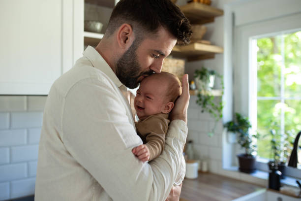 istock The father soothes the baby 2163056525