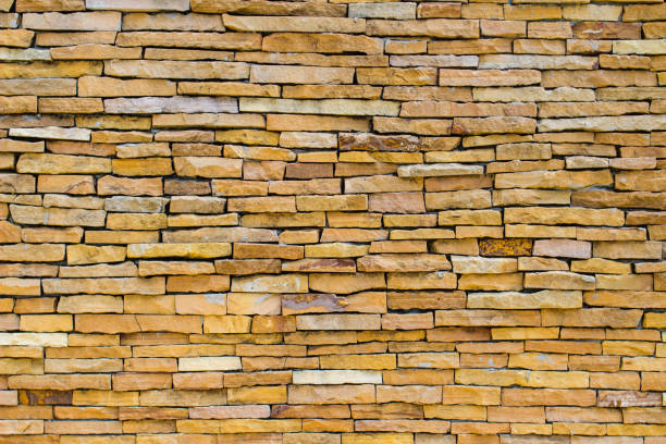 Brick wall background is a wall made of clay bricks, giving the structure strength and cement line between bricks that looks beautiful. It is popular to build a wall of ancient monuments.copy space,