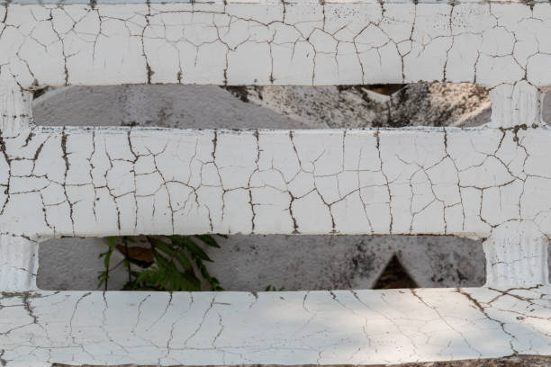 Old Brick Wall With White Paint Peeling Off, Showing Aged Surface, Rough Texture, And Industrial Decay Suitable For Backgrounds And Design Projects.