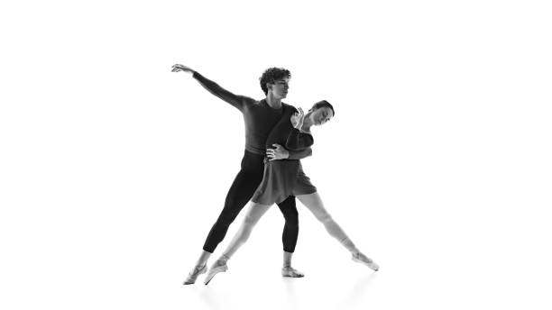 istock Precision and grace in motion. Ballet dancers, partners training against white studio background. Black and white filter. 2163060450
