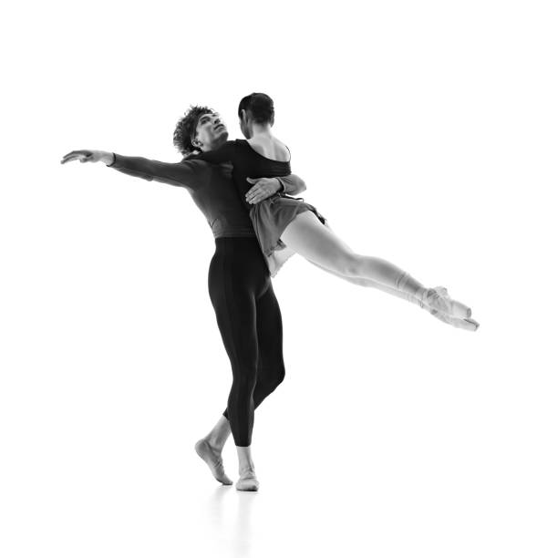 istock Graceful ballet partners practice their dance moves in motion against white studio background. Black and white filter. 2163060453