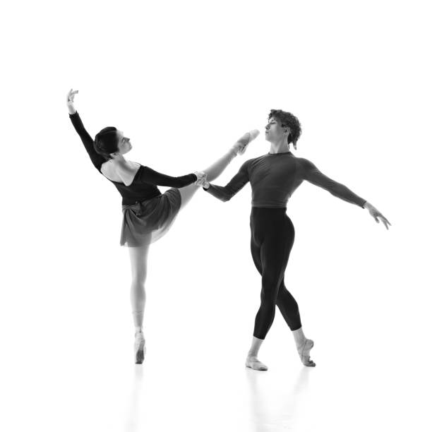 istock Ballet partners, man and woman enhancing their performance through practice against white studio background. Monochrome filter. 2163060464