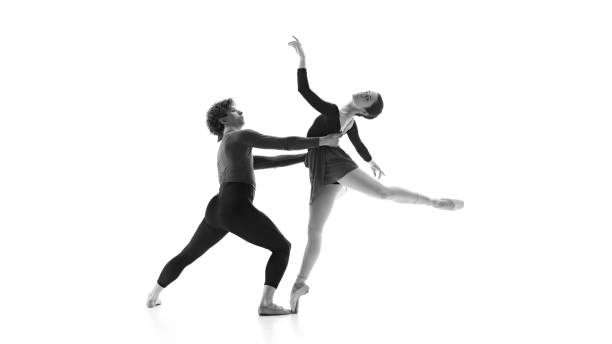 istock Fluid and synchronized. Ballet partners during practice against white studio background. Black and white filter. 2163060466