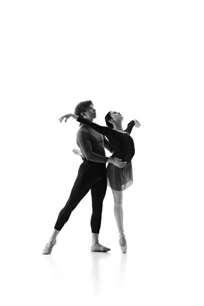 istock Talented young man and woman training, synchronizing their moves during practice session against white studio background. Sepia filter. 2163060472