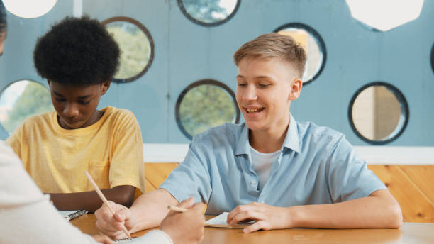 istock Young smart teenager writing and talking about topic at classroom. Edification. 2163061232