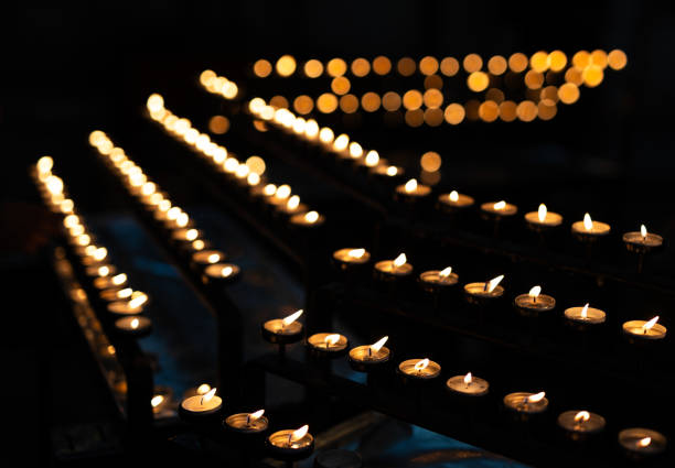 Tealight candles arranged in row in dark church