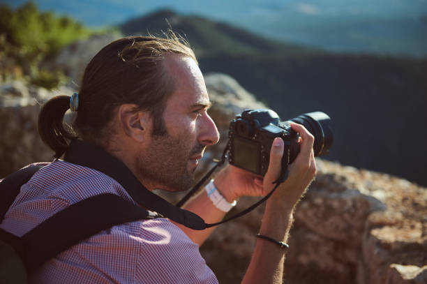 istock Photographer capturing scenic landscape on a rocky mountain 2163062898