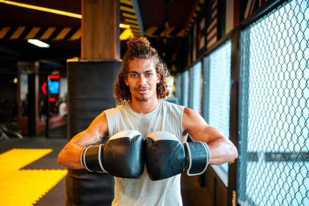 istock Hispanic Male Boxing Energetically In Gym 2163063441