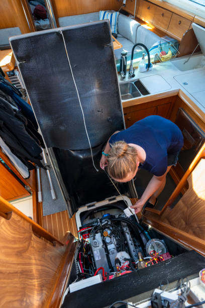 istock Woman maintains sailboat engine 2163066617