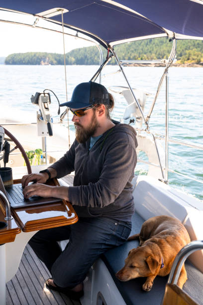 istock Man and dog on sailboat 2163066714