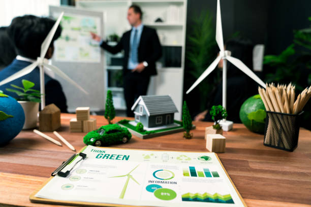 istock EV car model with mockup wind turbine on blurred background meeting. Quaint 2163066839