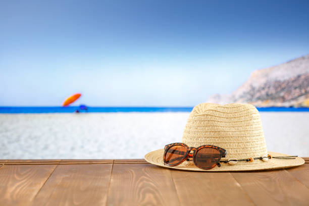 istock Beach accessories on summer wooden board deck on a tropical sandy beach. Seascape background. Copy space for montage products display. 2163067655