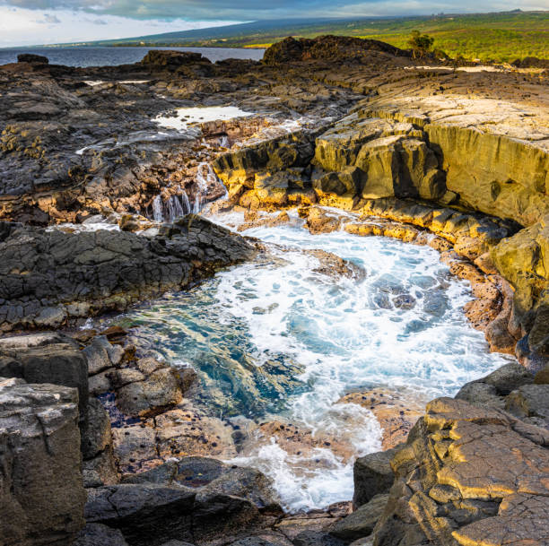 istock Water Rushing Over The Lava Sinks and Cliffs at Hokulia Shoreline Park 2163068724