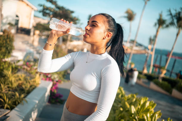 istock Fit Hispanic Woman Drinking Water Post-Workout 2163073437