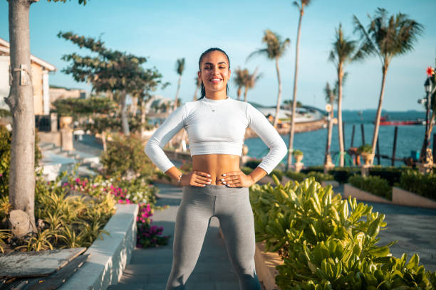 istock Active Hispanic Woman Stretching by the Sea 2163073458