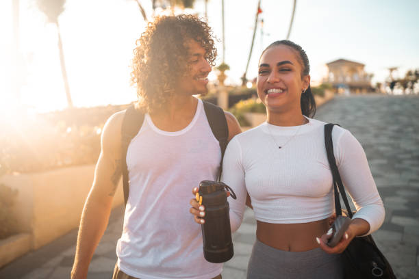 istock Fitness Forward Hispanic Couple Hydrating Post-Beach Exercise 2163073952