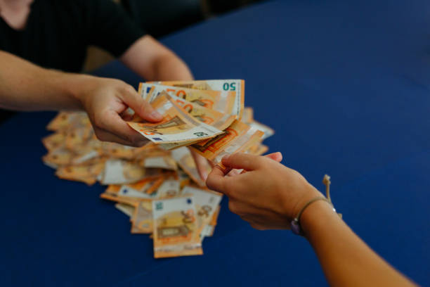 istock upper view of two person hands passing each other banknotes over the table 2163075049